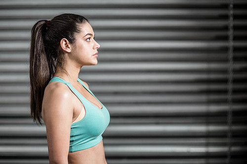 Portrait of fit woman looking up at crossfit gym