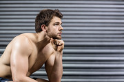 Thoughtful man looking up at crossfit gym