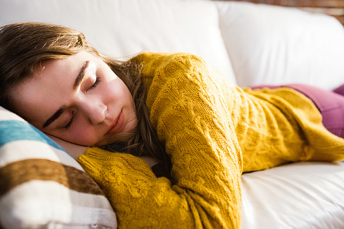 Pretty woman sleeping on the couch in the living room