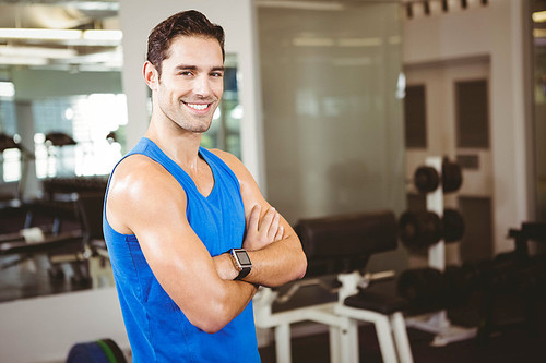 Handsome man with arms crossed  in the gym