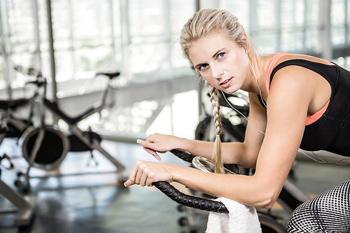 Fit woman on exercise bike at the gym