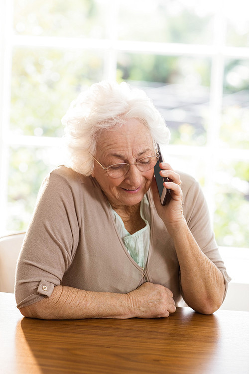 Elderly woman phone calling at home