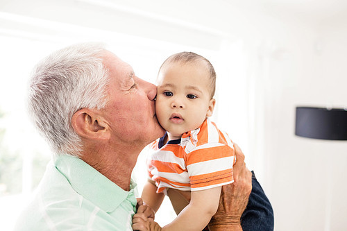 Senior man playing with his grandson at home