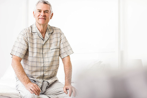 Peaceful senior man smiling at home