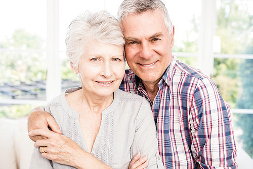 Portrait of smiling senior couple at home