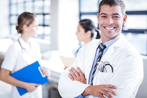 Doctor smiling at the camera in the hospital