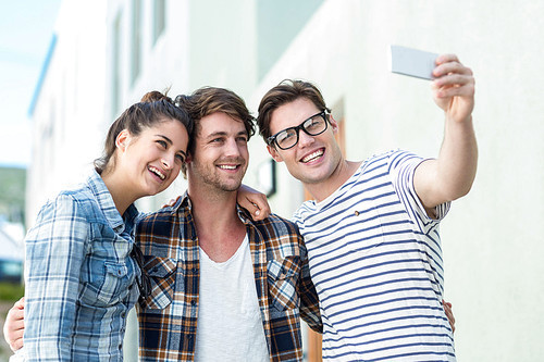 Hip friends taking selfie on the street