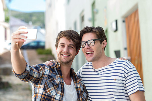 Hip friends taking selfie on the street