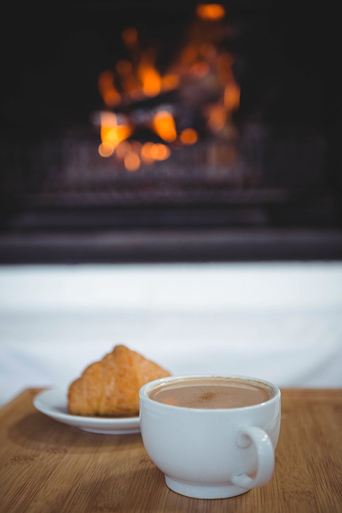 Coffee cup on table next to sweet food on table