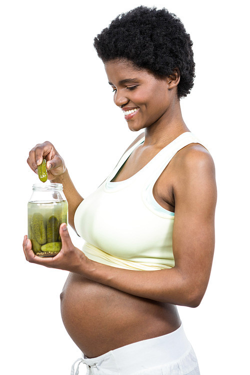 Pregnant woman eating pickles on white background