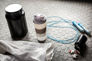 Supplements and rope on the floor at the crossfit gym