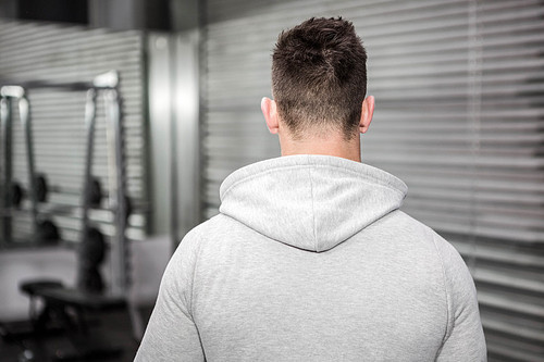 Rear view of man with grey jumper at the crossfit gym