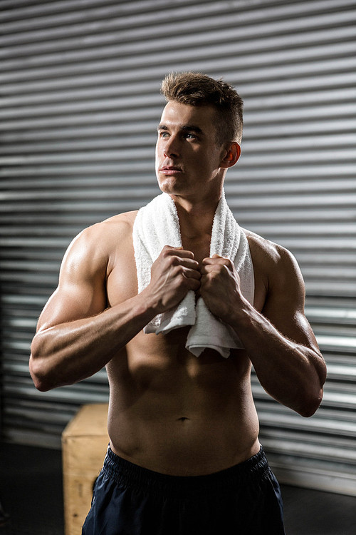 Shirtless man with towel around neck at the crossfit gym