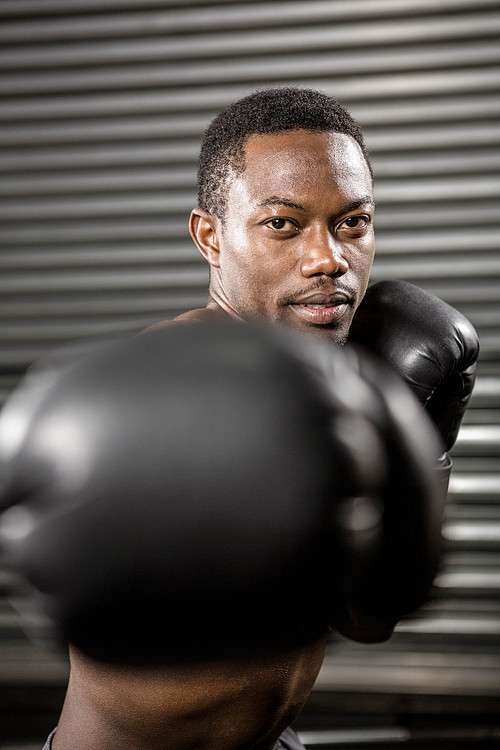 Shirtless boxer training at the crossfit gym