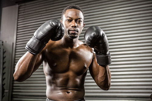 Shirtless boxer training at the crossfit gym