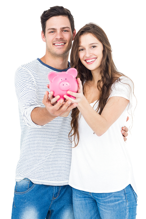 Couple holding piggy bank on white background