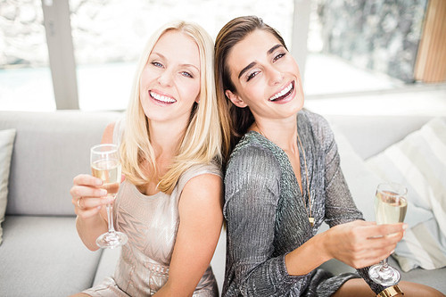 Portrait of beautiful women smiling and having champagne flute