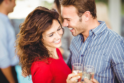 Romantic couple having drinks at the party