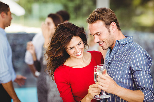 Romantic couple having drinks at the party