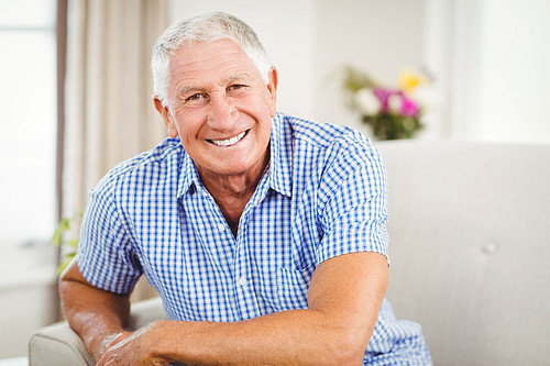 Senior man  and smiling in living room