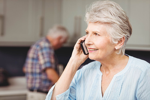 Senior woman smiling while talking on phone
