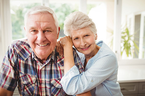 Portrait of senior couple smiling at home