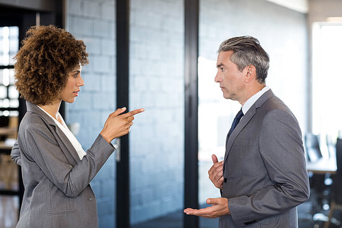 Businessman and businesswoman having a discussion in office