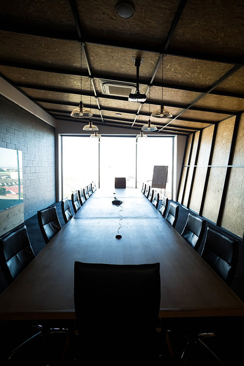 An empty modern conference room with conference table in office