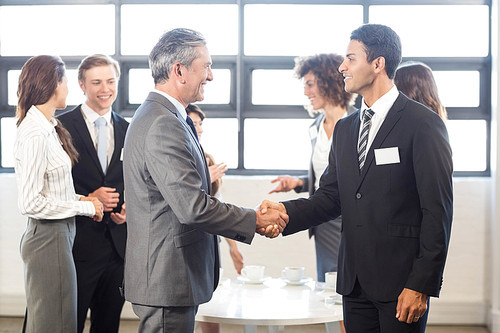 Business team standing together and interacting in office