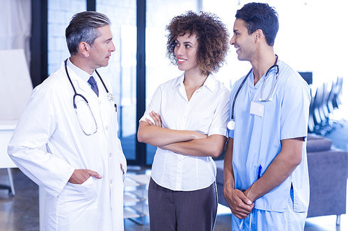 Doctor having a discussion with colleagues in hospital