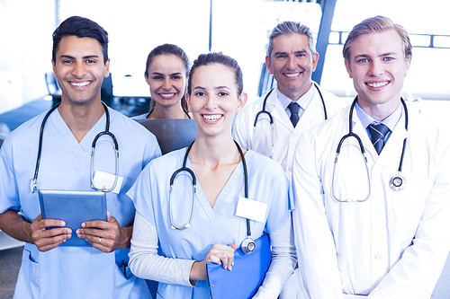 Portrait of medical team standing together and smiling in hospital