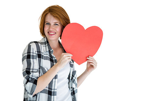 Fashion hipster holding a red heart shape on white background