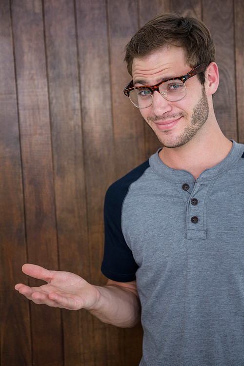 Handsome hipster wearing nerd glasses on wooden background