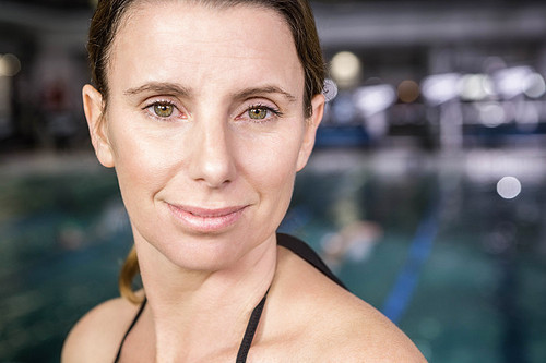 Portrait of smiling woman at the swimming pool