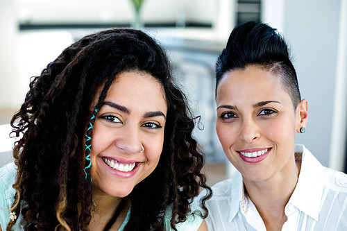 Portrait of lesbian couple smiling at camera
