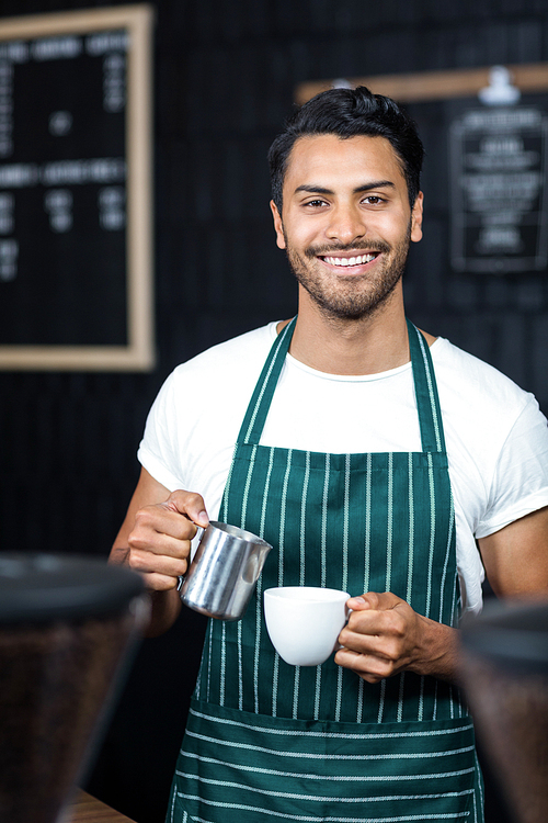 Handsome waiter serving coffee cup at the coffee shop