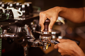 Close-up of barista preparing coffee in a cafe