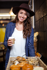 Smiling woman holding disposable cup in the bar