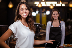 Smiling woman in the bar looking at the camera