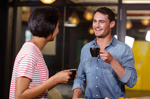 Smiling couple having coffee at the bar