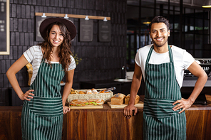 Smiling baristas looking at the camera in the bar