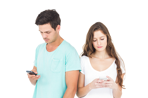 Concentrated couple using their smartphones on white background