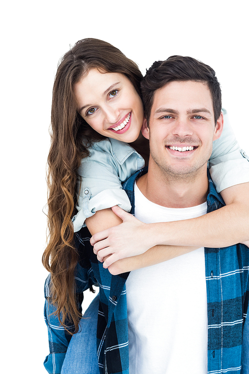 Cute couple embracing and looking the camera on white background