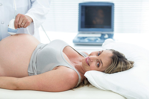 Pregnant woman receiving ultrasound treatment in hospital