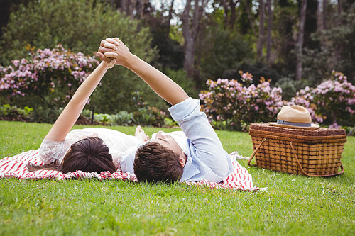 Young couple relaxing on blanket in garden