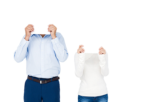 Couple covering face with paper on white screen