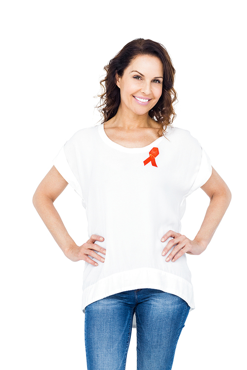 Pretty brunette wearing red aids awareness ribbon against white background
