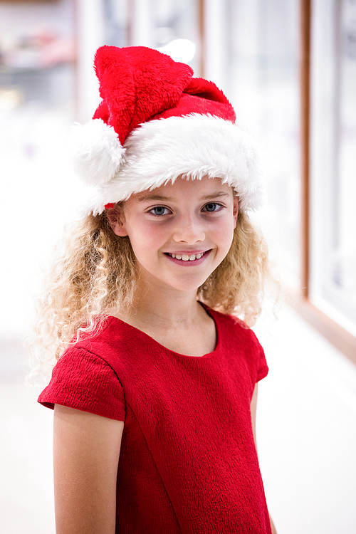 Girl in Christmas attire smiling in a shop