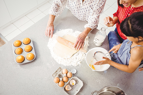 High angle view of girl helping family in preparing food at home