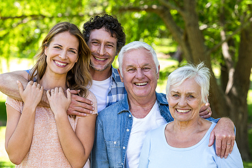 Smiling family hugging in a park